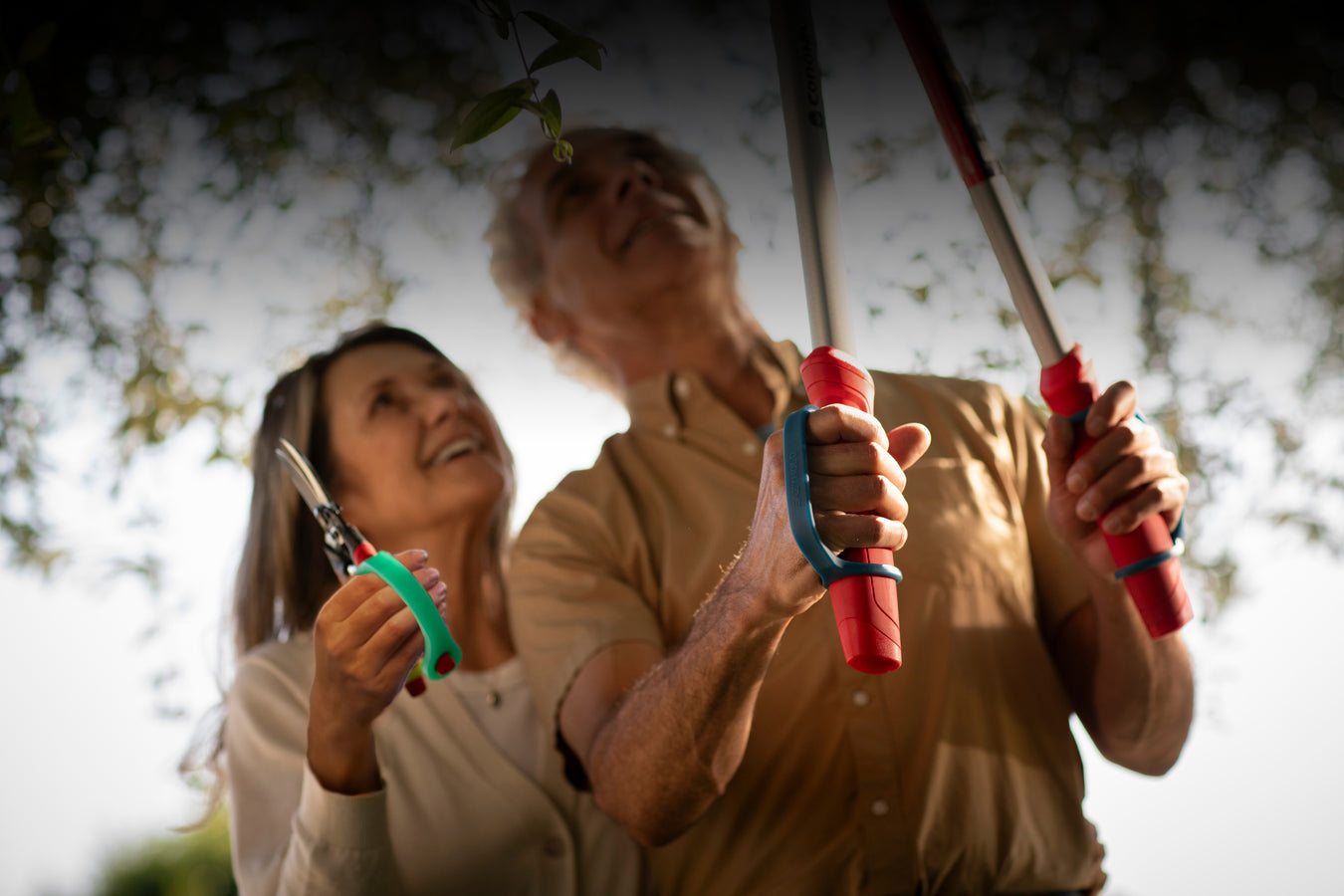 Two people holding gardening shears in a garden setting using EaZyHold products.