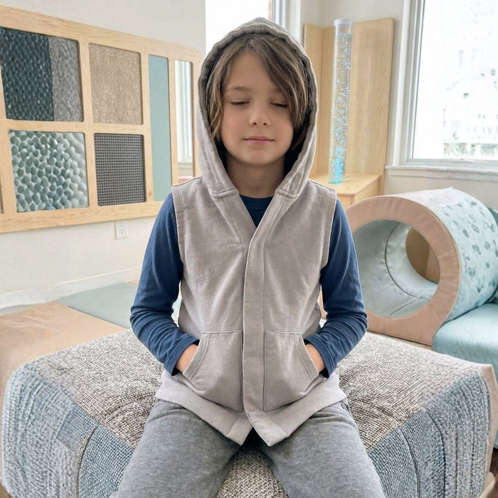 Child wearing the Sense-ational You QuietSense Sound Reducing Sensory Youth Vest in classroom setting