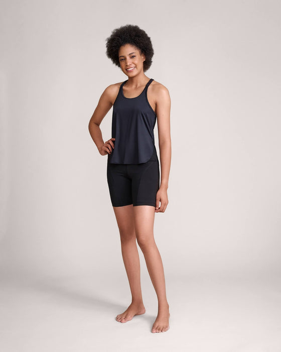 A model with short dark curly hair wearing Slick Chicks Adaptive Athletic Tank Top against a plain beige background