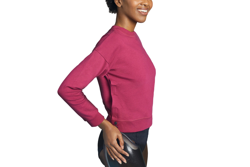 Side angle of a model wearing Slick Chicks Adaptive Crewneck Sweatshirt in plum, against a solid white background