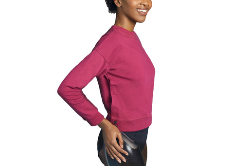 Side angle of a model wearing Slick Chicks Adaptive Crewneck Sweatshirt in plum, against a solid white background