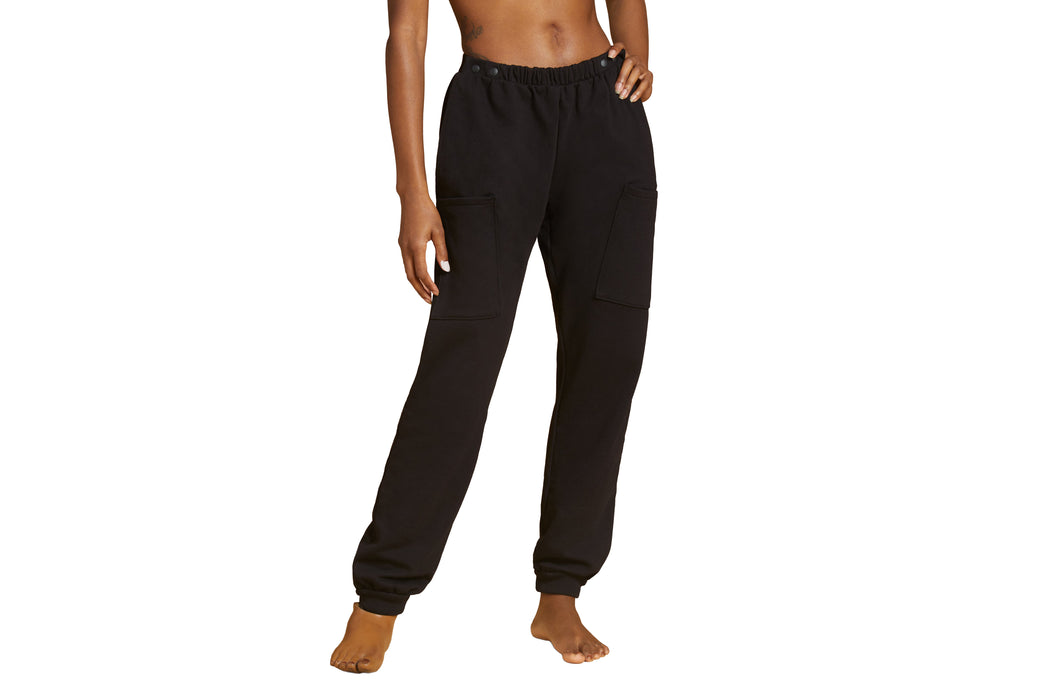 Front angle of a model wearing Slick Chicks Adaptive Fitted Lounge Joggers in black against a white background