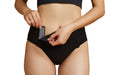 Close-up of a model wearing Slick Chicks Adaptive High Waist Panty in black, pulling open the VELCRO Brand Fasteners with two hands against a plain white background