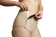 Close-up of a model wearing Slick Chicks Adaptive Leakproof Underwear in beige, pulling open the VELCRO Brand Fasteners with both hands against a plain white background