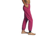 Side angle of a model wearing Slick Chicks Adaptive Side Zip Joggers in plum against a plain white background