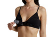 Close up of a model wearing Slick Chicks Adaptive Wireless Front Fastening Bra in black, demonstrating the VELCRO Brand Fasteners that open the bra from the front, against a white background