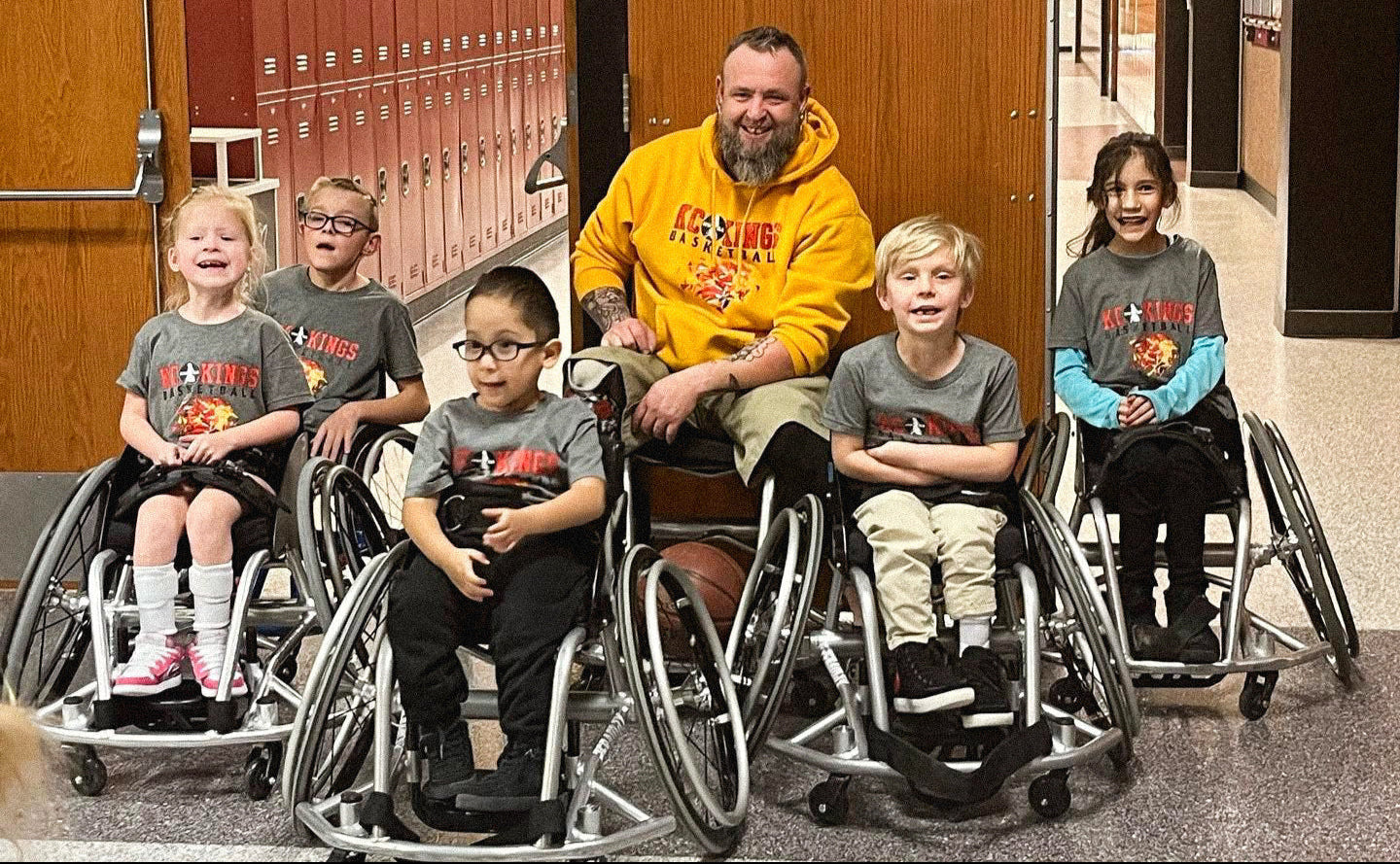 Group portrait of the team of 5 Kansas City Kings Youth Wheelchair Basketball team with Jason Loftiss