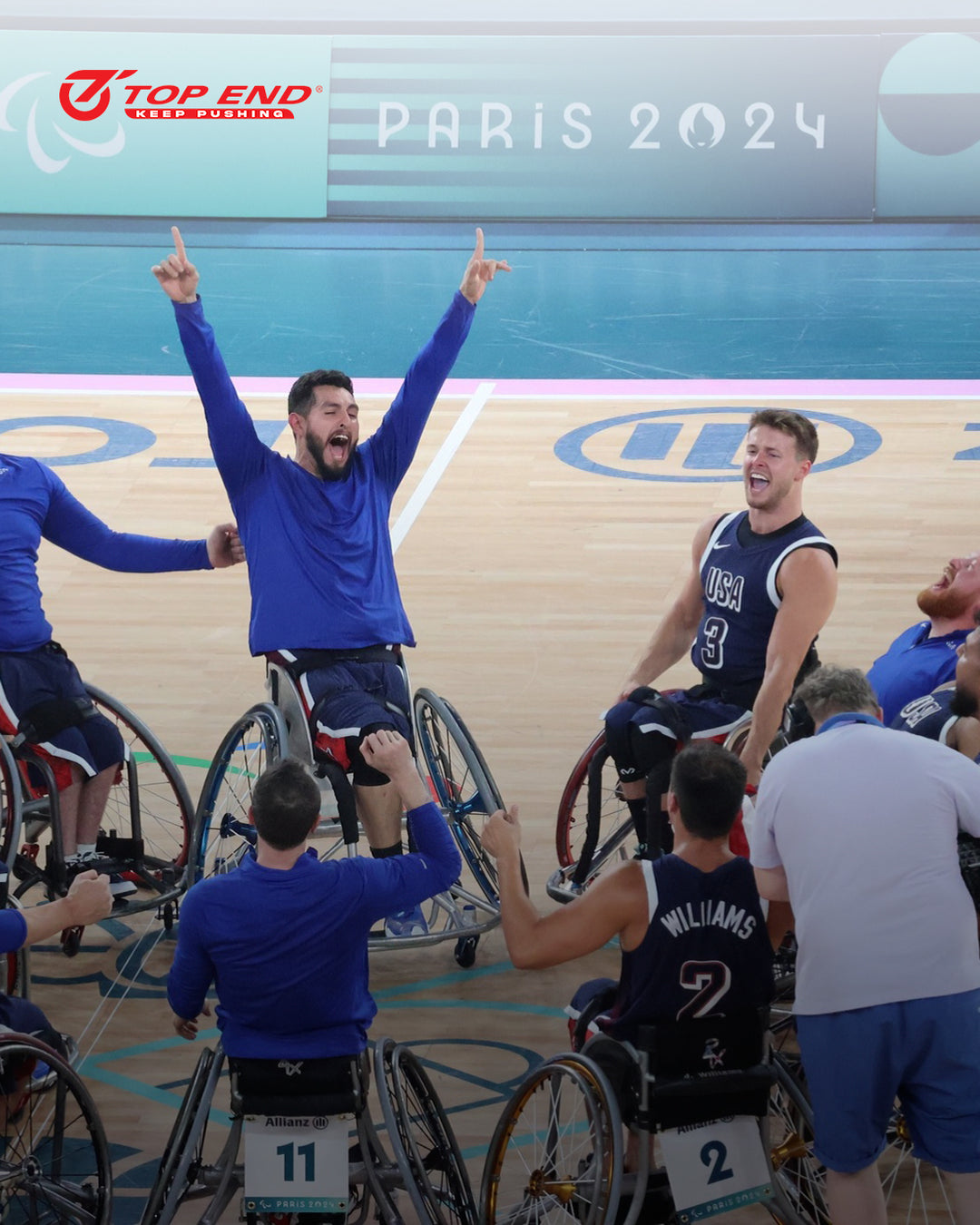 Team USA Wheelchair basketball players celebrating on a court after winning gold in the 2024 Paris Paralympics.
