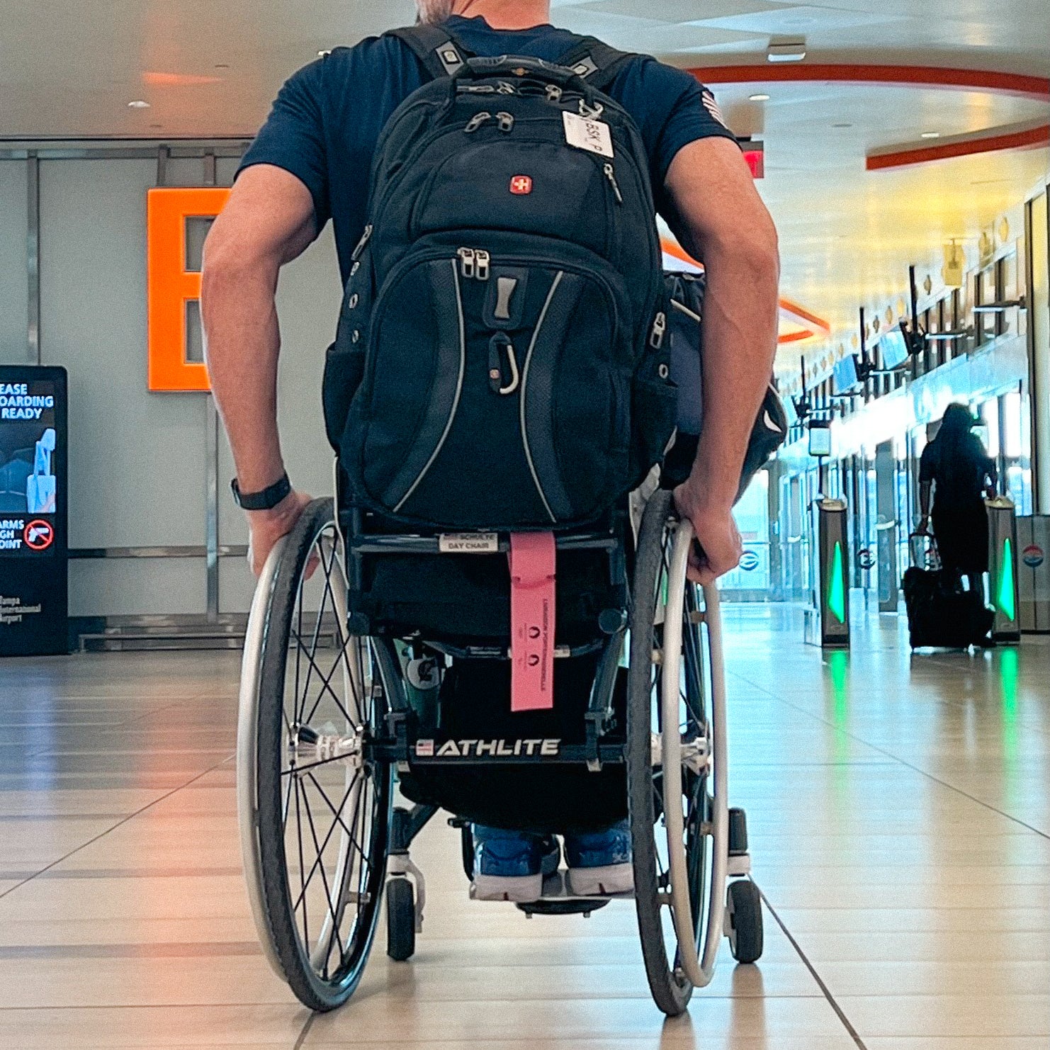 Person using a Top End Athlite Wheelchair in an airport.