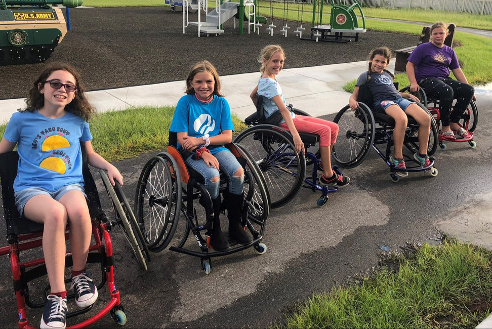 Children with disabilities using wheelchairs on a playground.