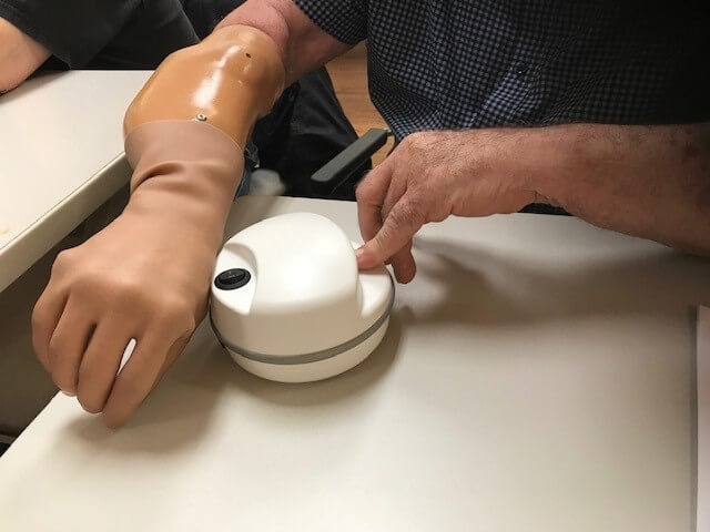 Person with arm arm amputation trimming their nails with the Lil Nipper Adaptive Nail Clippers