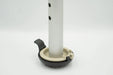 Versa Coast walker footing installed on a silver walker leg, with the tan base puck seated in the black coaster and its quick release tab, on a white background