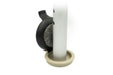 Versa Select black coaster flipped up on its hinge beside a silver walker leg, showing its gray carpeted pad above the tan base puck on a white background