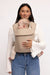 Woman holding a baby in a WildBird Desert Lark Aerial Buckle Baby Carrier on a white background