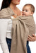 Front side detail of woman holding a baby in a WildBird Desert Lark Linen Baby Sling on a white background