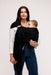 Woman holding a baby in a WildBird Raven Linen Baby Sling on a white background