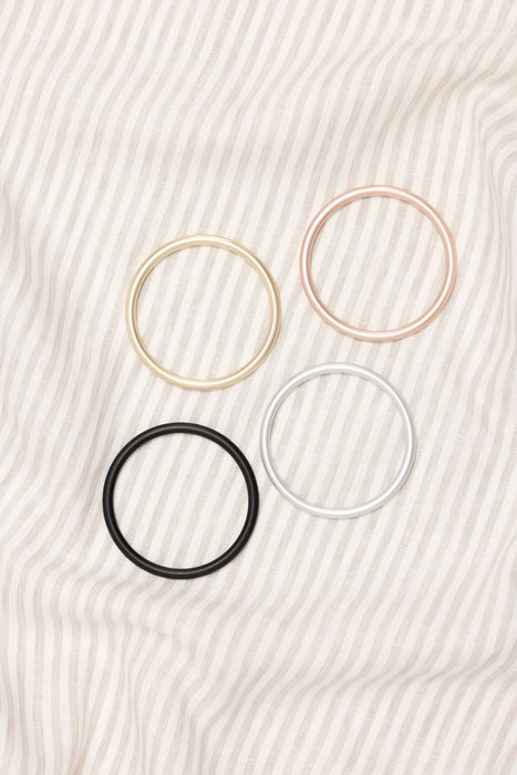 Set of four rings for the  on a textured beige background