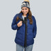Person wearing a blue puffer jacket with the ZipperBuddy No-Sew Hook & Loop Jacket Closure Attachment on a white background