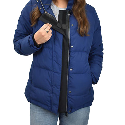 Detail of a person wearing a blue puffer jacket with the ZipperBuddy No-Sew Hook & Loop Jacket Closure Attachment on a white background