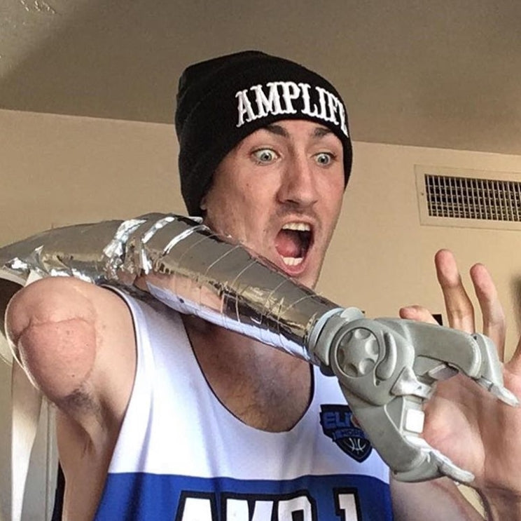 Team Amplife® Ambassador Aaron Soetaert wearing the Amplife® Beanie while holding his prothetic arm and making a funny face