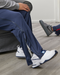 Side detail of people wearing the befree zipOns Adult Lightweight Adaptive Pants in a living room
