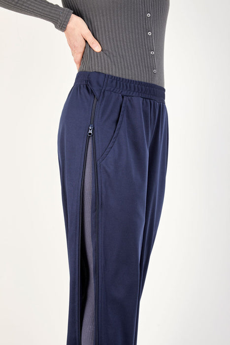 Detail of side almost completely unzipped of the befree zipOns Adult Lightweight Adaptive Pants worn on model on a white background