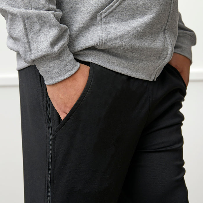 Side detail of befree zipOns Adult Lightweight Adaptive Pants worn on model on a white background