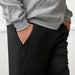 Side detail of befree zipOns Adult Lightweight Adaptive Pants worn on model on a white background