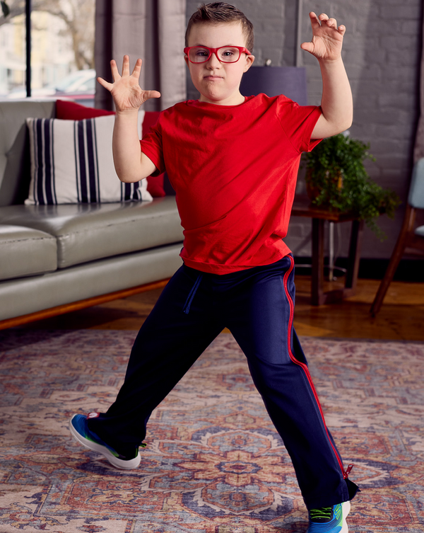 Child wearing the befree zipOns Youth Heavyweight Adaptive Pants in a living room