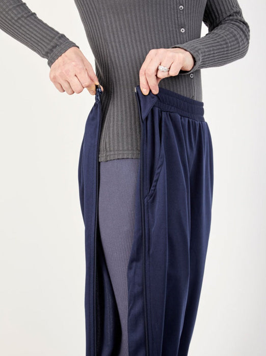 Detail of side unzipped of the befree zipOns Youth Lightweight Adaptive Pants worn on model on a white background