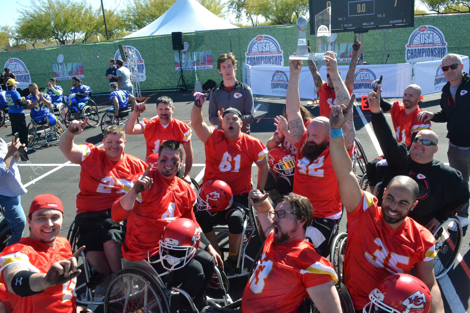 Kansas City Chiefs Wheelchair Football team celebrating a win together.