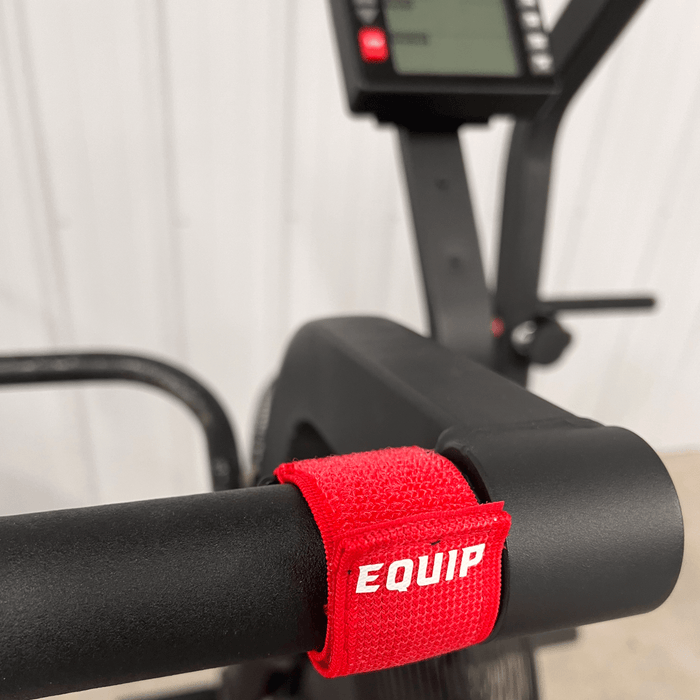 Detail of Equip Products Left Neglect Red Straps attached to an assault bike handle.