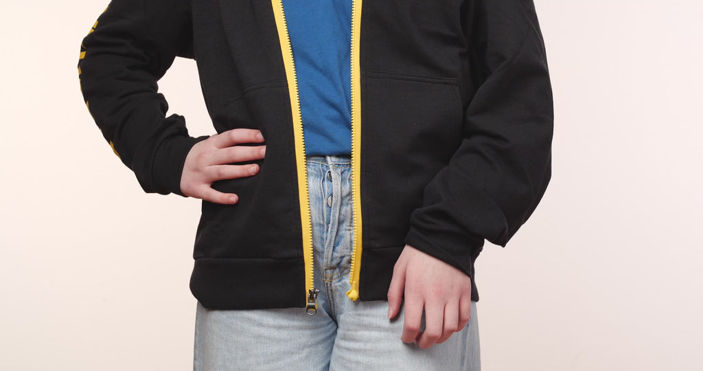 MagZip Adaptive Lightweight Hoodie with Magnetic Zipper being zipped up with one hand on a white background