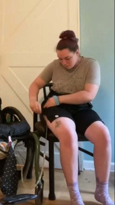 Person putting on the befree zipOns Adult Lightweight Adaptive Shorts in their bedroom