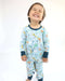 Child smiling while wearing a Rainn Bamboo Critter Hollow Crescent Zipp Jammies on a white background
