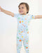 Child spreading open their arms while wearing a Rainn Bamboo Cosmic Pull Up Romper on a white background
