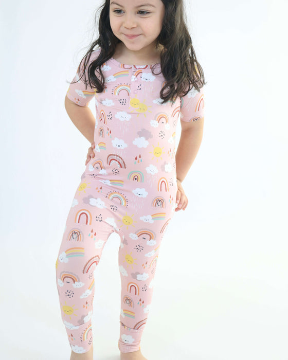 Child wearing a Rainn Bamboo Rainnbow Pull Up Romper on a white background