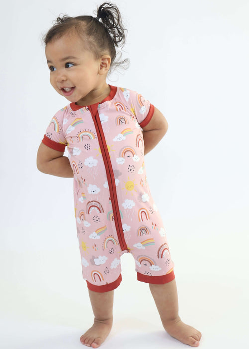 Baby wearing a Rainn Bamboo Rainnbow Short Zipp Romper on a white background