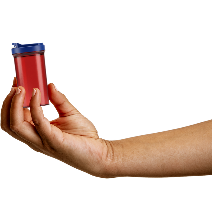 Hand holding a red translucent SnapSlide prescription vial with a navy blue cap on a white background