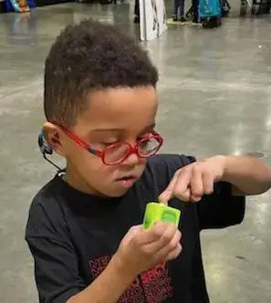 Young boy using ClipDifferent POD adaptive nail clipper