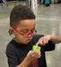 Young boy using Lil Nipper adaptive nail clipper by ClipDifferent